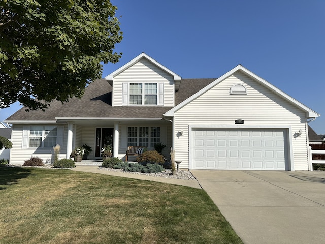 view of front of property with a front yard and a garage