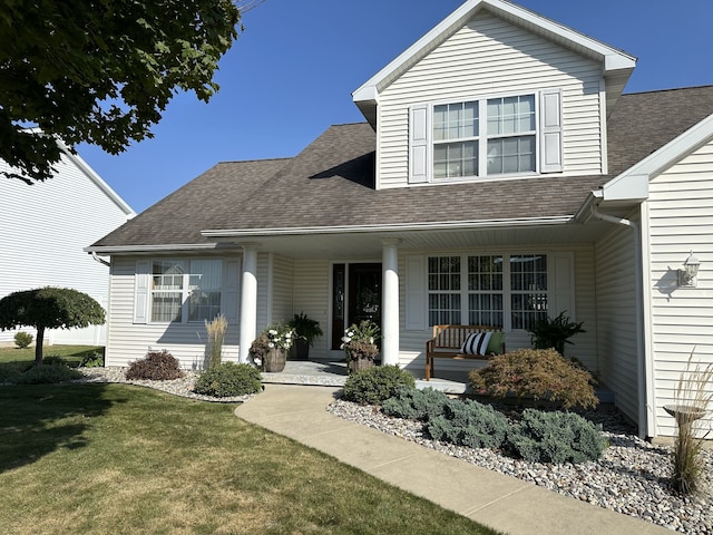 view of front of home with covered porch and a front yard