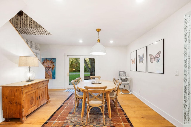 dining room featuring french doors and light hardwood / wood-style flooring