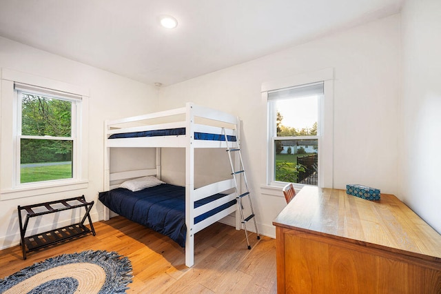 bedroom featuring hardwood / wood-style flooring and multiple windows