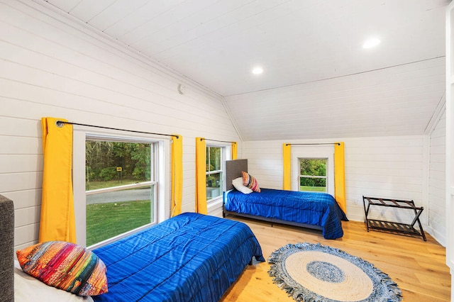 bedroom featuring wood walls, wooden ceiling, lofted ceiling, and hardwood / wood-style flooring