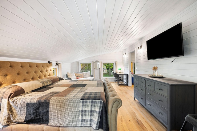 bedroom with wood ceiling, wood walls, light hardwood / wood-style floors, and lofted ceiling