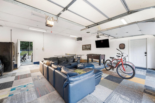 garage featuring a garage door opener and stainless steel refrigerator