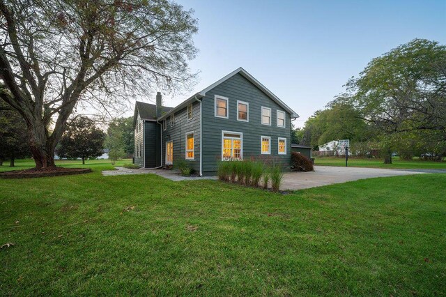 9695 Community Hall Rd, Union Pier, MI 49129 - view of side of home featuring a yard and a chimney
