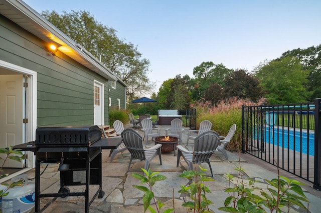 view of patio featuring a fire pit and a grill