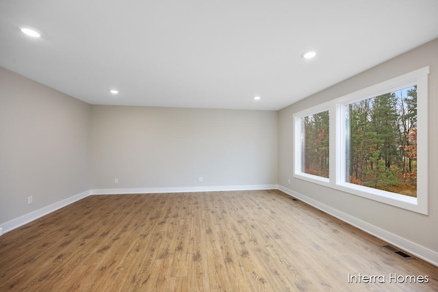 spare room with light hardwood / wood-style flooring