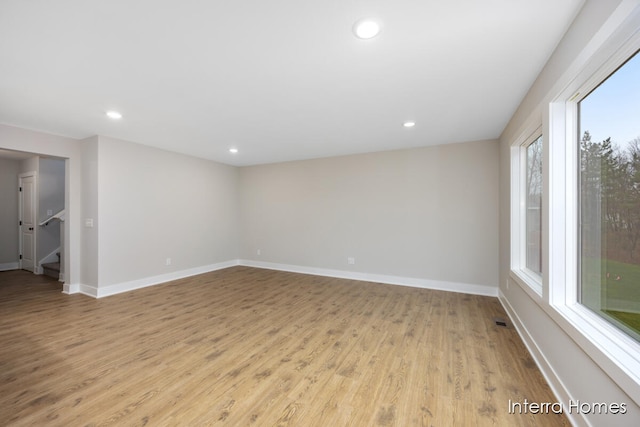 spare room with light hardwood / wood-style flooring