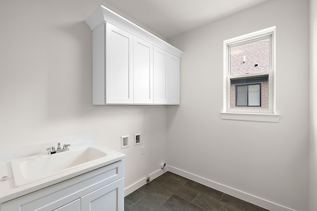 washroom with cabinets, washer hookup, and sink