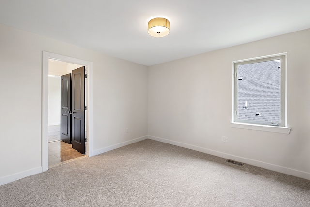 empty room featuring light carpet