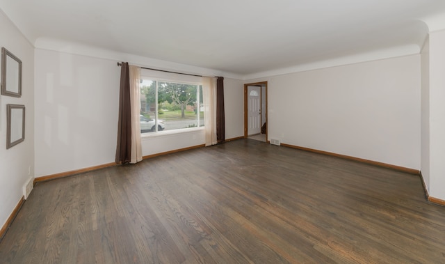 spare room featuring dark hardwood / wood-style flooring