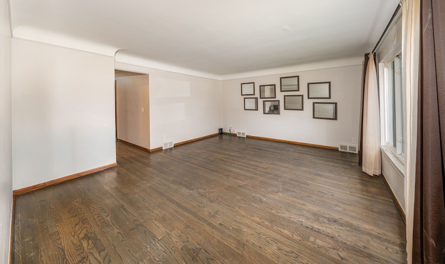 unfurnished room with dark hardwood / wood-style floors