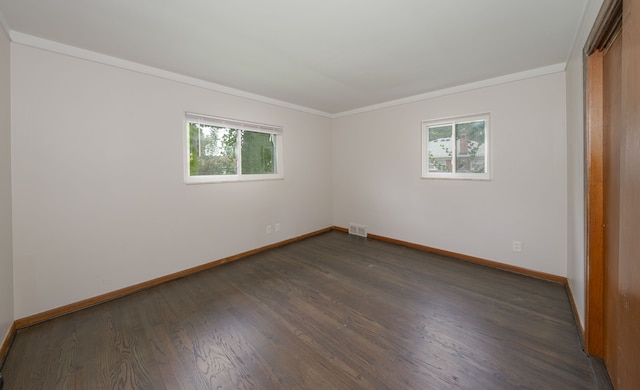 spare room with crown molding and dark hardwood / wood-style floors