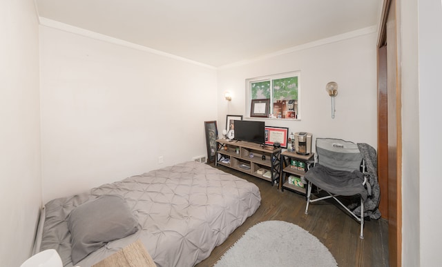 bedroom with dark hardwood / wood-style flooring and ornamental molding