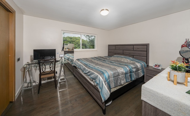 bedroom with dark hardwood / wood-style floors