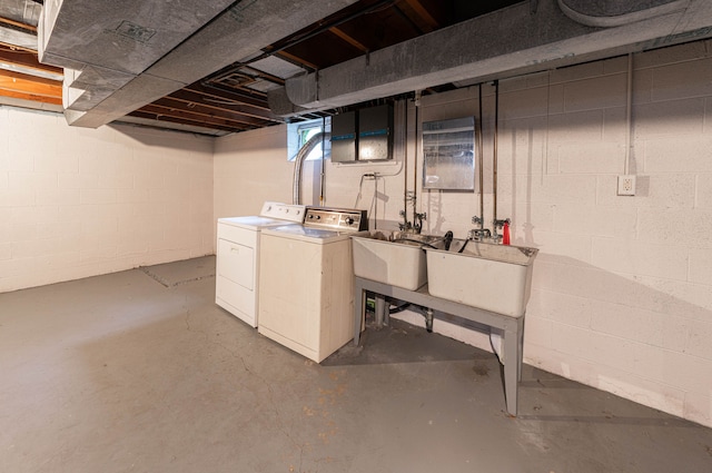 basement featuring separate washer and dryer and sink