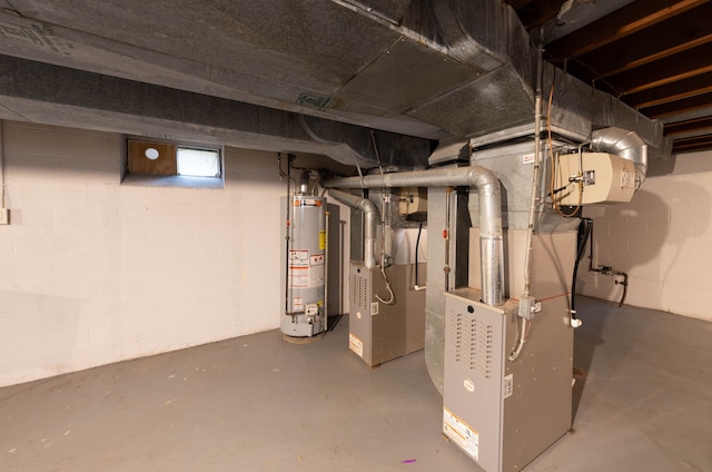 utility room with heating unit and water heater