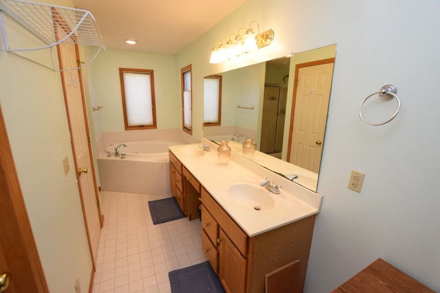 bathroom featuring vanity, shower with separate bathtub, and tile patterned floors