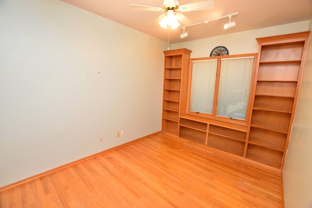 unfurnished room featuring hardwood / wood-style flooring, track lighting, and ceiling fan