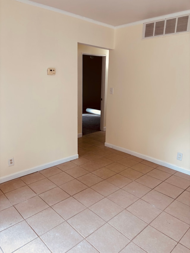 unfurnished room with crown molding and light tile patterned flooring