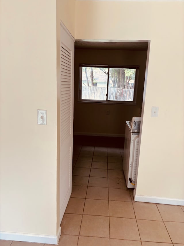 hallway featuring light tile patterned flooring