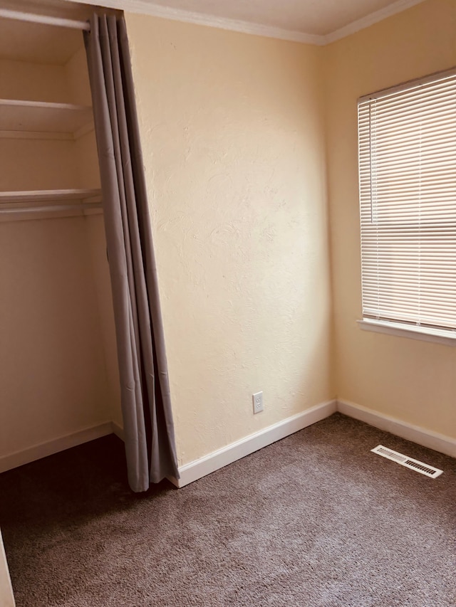 unfurnished bedroom featuring carpet and ornamental molding