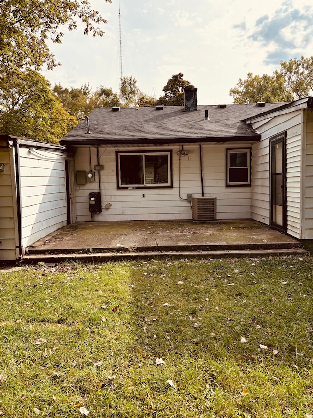 back of house featuring a yard, central AC, and a patio area