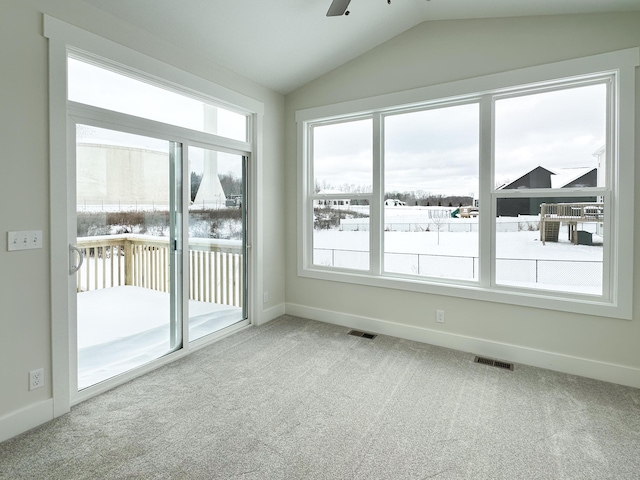 empty room with lofted ceiling, carpet floors, and ceiling fan