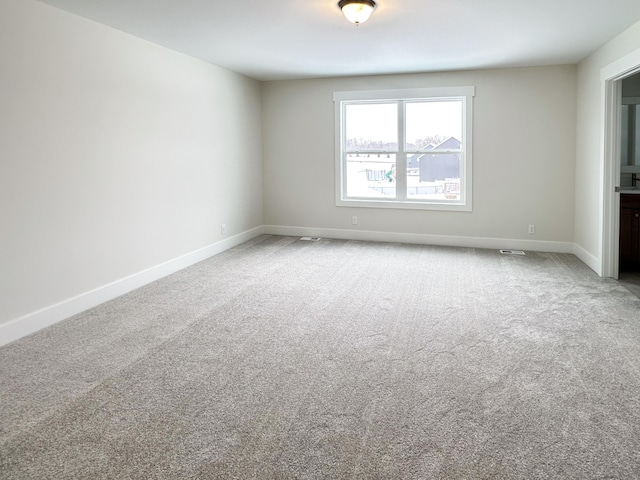 unfurnished room featuring carpet