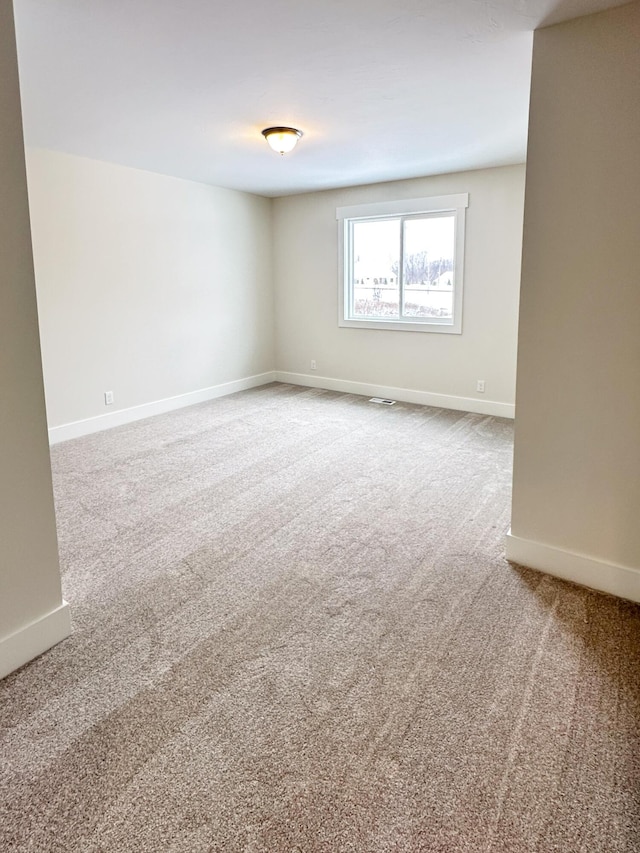 unfurnished room featuring carpet flooring