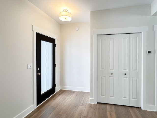 foyer entrance with light hardwood / wood-style floors