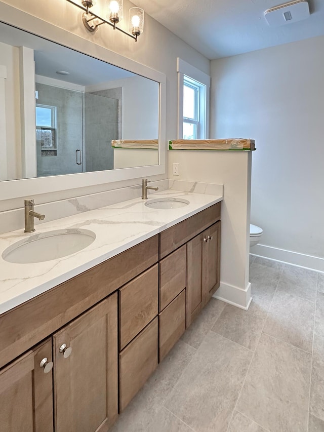 bathroom with walk in shower, vanity, and toilet