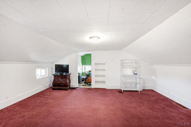 additional living space featuring carpet floors and lofted ceiling