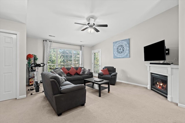 living room featuring ceiling fan, lofted ceiling, and light carpet