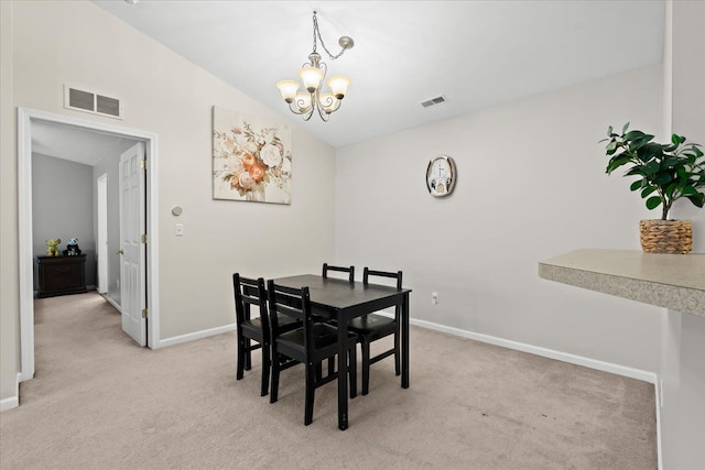 carpeted dining space featuring a chandelier and lofted ceiling