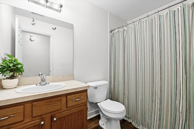 bathroom featuring a shower with shower curtain, vanity, wood-type flooring, and toilet