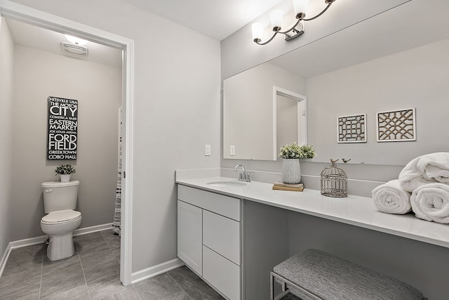 bathroom featuring tile patterned flooring, vanity, and toilet