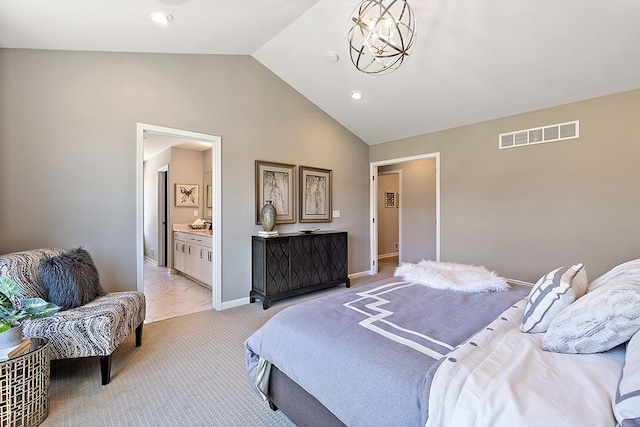 bedroom with vaulted ceiling, an inviting chandelier, light carpet, and ensuite bath