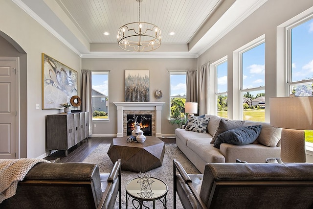 living room featuring wooden ceiling, a raised ceiling, dark hardwood / wood-style floors, a notable chandelier, and ornamental molding