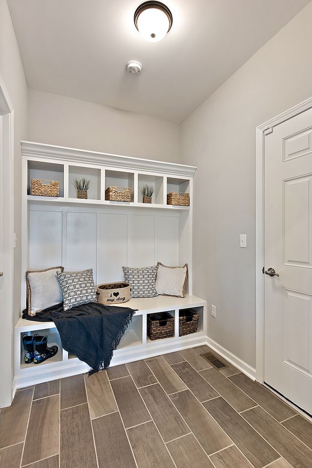 mudroom with dark hardwood / wood-style floors