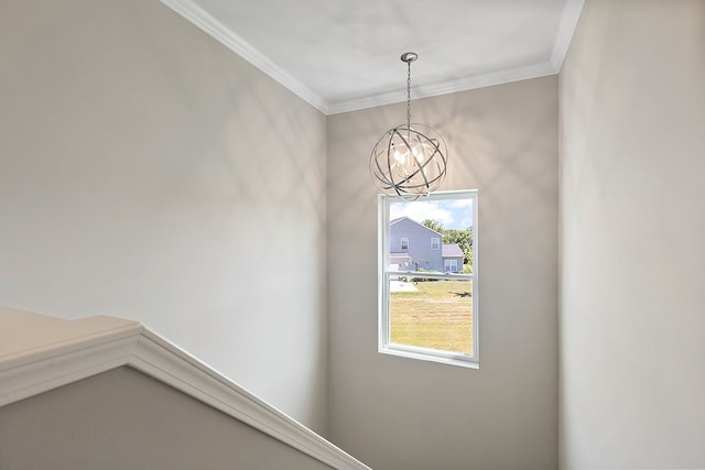 interior space with crown molding and an inviting chandelier