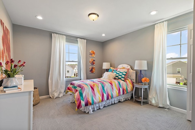 carpeted bedroom featuring multiple windows