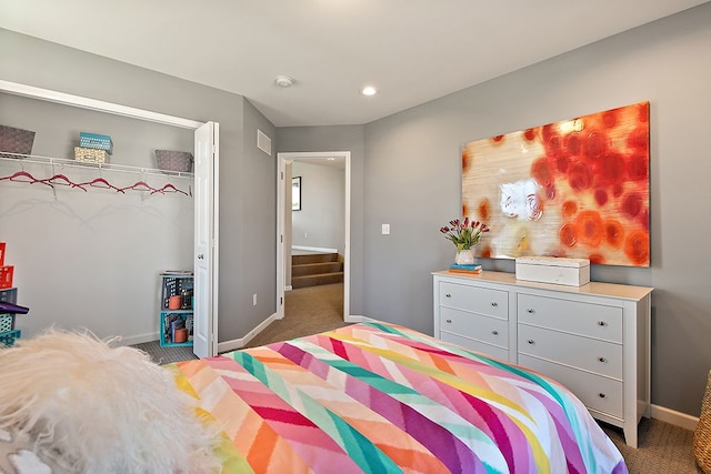 carpeted bedroom with a closet