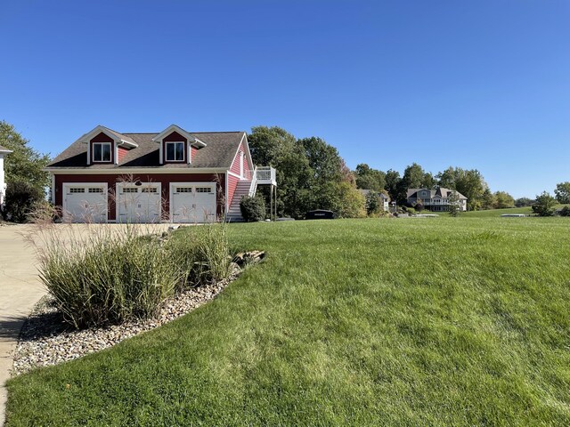 23739 Grandview Ct, Sturgis, MI 49091 - view of side of property featuring a garage, a lawn, and concrete driveway