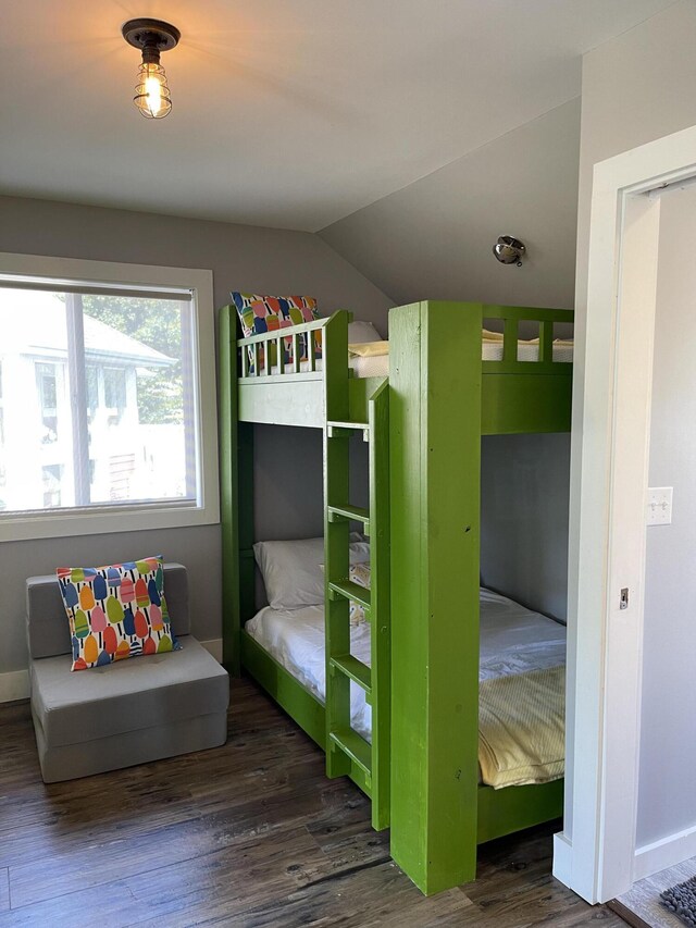 23739 Grandview Ct, Sturgis, MI 49091 - bedroom featuring lofted ceiling, wood finished floors, and baseboards