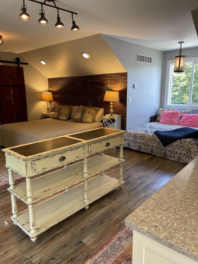 23739 Grandview Ct, Sturgis, MI 49091 - bedroom with a barn door, dark wood-style flooring, and recessed lighting