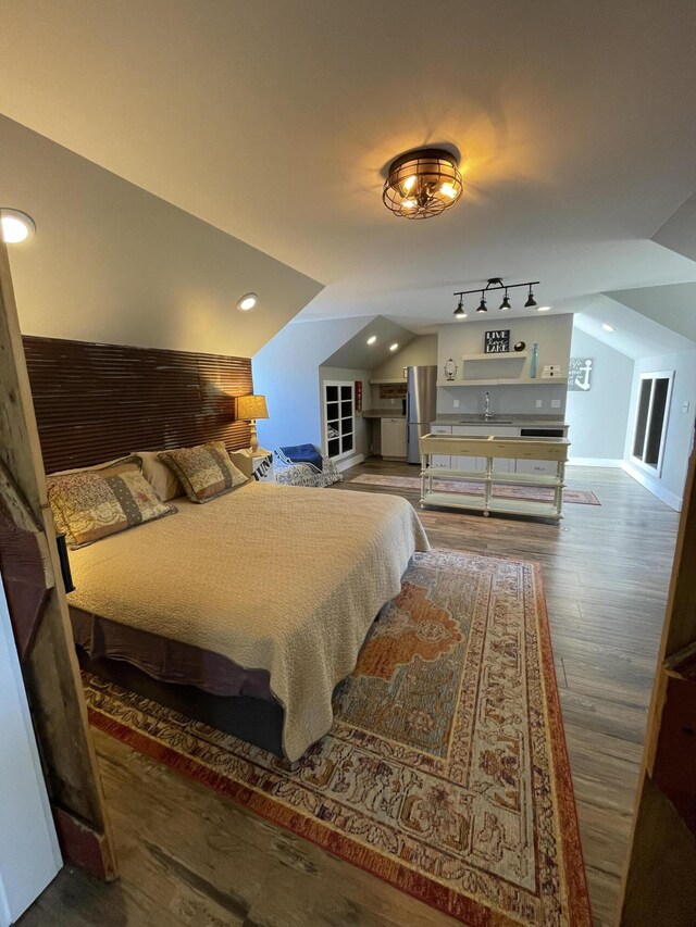 23739 Grandview Ct, Sturgis, MI 49091 - bedroom with lofted ceiling, a sink, wood finished floors, and recessed lighting
