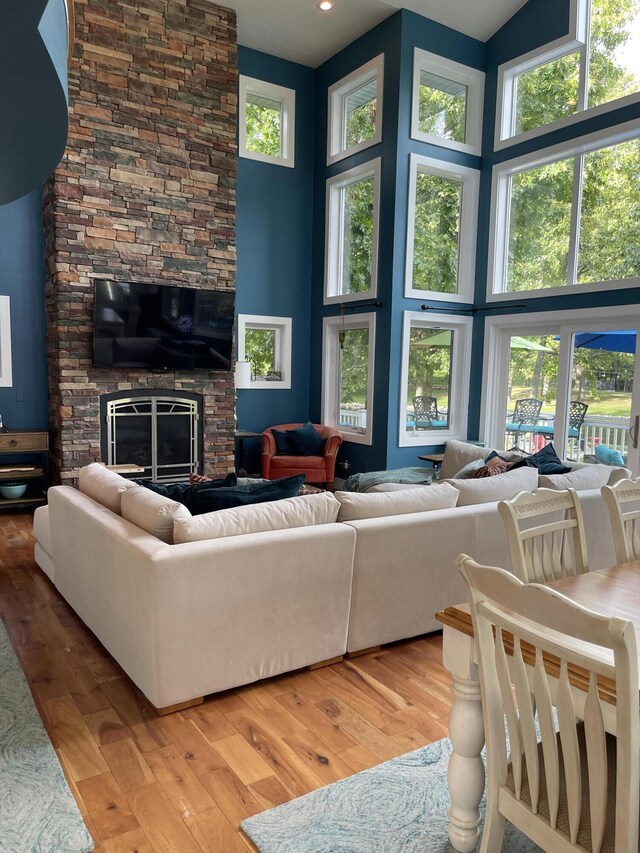 23739 Grandview Ct, Sturgis, MI 49091 - living area featuring a towering ceiling, wood finished floors, and a stone fireplace