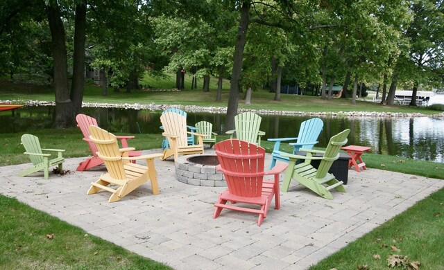 23739 Grandview Ct, Sturgis, MI 49091 - view of patio / terrace with an outdoor fire pit and a water view