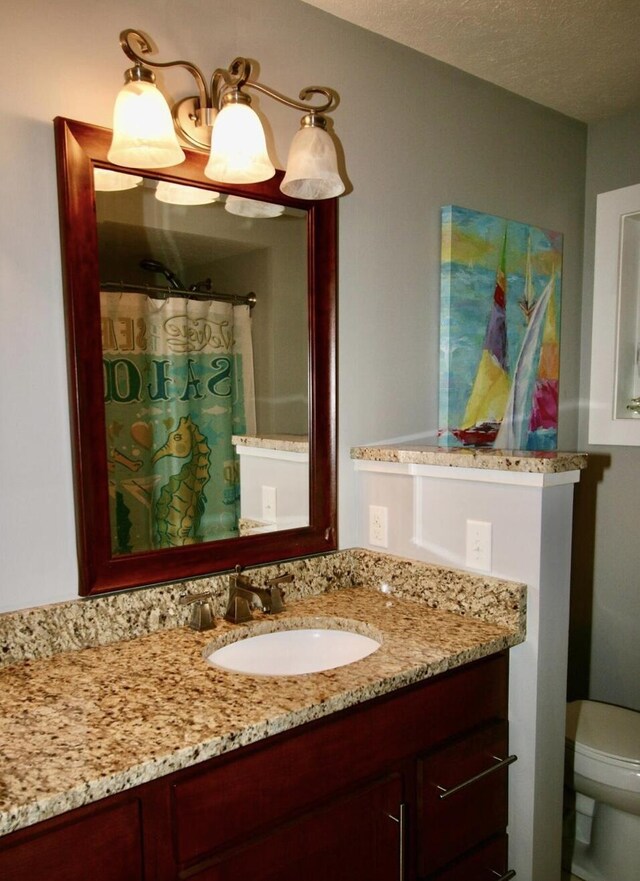 23739 Grandview Ct, Sturgis, MI 49091 - full bathroom featuring toilet, vanity, and a textured ceiling