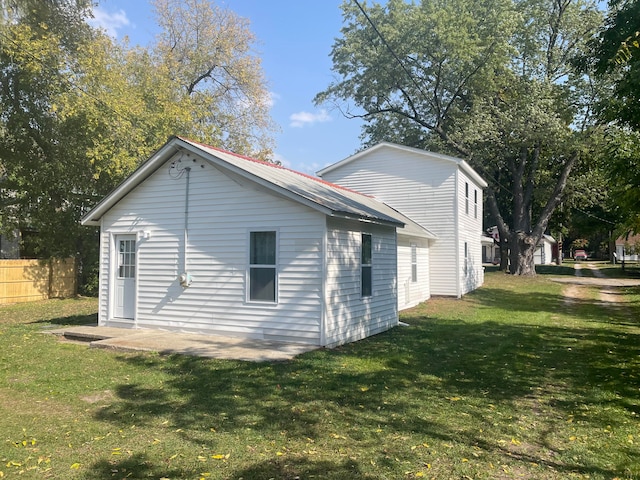 view of side of home with a lawn